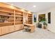 Bright home office with custom built-in shelving, carpet, and a large window for natural light at 16416 E Powers Pl, Centennial, CO 80015
