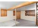View of basement with wood trim, built-in shelves, wood pillar, and carpeted floor at 9000 W 4Th Pl, Lakewood, CO 80226