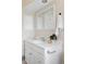 Bathroom vanity features white cabinets and countertops with updated fixtures at 9000 W 4Th Pl, Lakewood, CO 80226