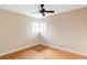An empty bedroom featuring hardwood floors, a ceiling fan and a corner window at 9000 W 4Th Pl, Lakewood, CO 80226