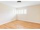 The bedroom features hardwood floors and large window at 9000 W 4Th Pl, Lakewood, CO 80226