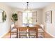 Dining room features a modern chandelier, hardwood flooring, and a view of the backyard at 9000 W 4Th Pl, Lakewood, CO 80226