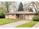 Ranch-style home showcasing a lovely front yard and a convenient driveway leading to an attached garage at 9000 W 4Th Pl, Lakewood, CO 80226