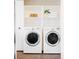 Laundry room with side-by-side front load washer and dryer and open shelves at 9000 W 4Th Pl, Lakewood, CO 80226