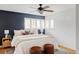 Spacious main bedroom featuring a dark accent wall, large window, and hardwood floors at 9000 W 4Th Pl, Lakewood, CO 80226