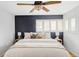 This is the main bedroom with ceiling fan and accent wall and big windows at 9000 W 4Th Pl, Lakewood, CO 80226