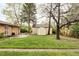 View of home's backyard and storage shed with green lawn and mature trees at 9000 W 4Th Pl, Lakewood, CO 80226