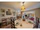 Dining area with a round table set for tea, featuring elegant decor and open access to other living spaces at 3831 S Hillcrest Dr, Denver, CO 80237