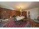 Cozy dining room with a brick fireplace and a vintage-style chandelier, creating a warm and inviting atmosphere at 3831 S Hillcrest Dr, Denver, CO 80237