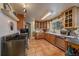 Well-lit kitchen with stainless steel appliances and tile flooring at 3831 S Hillcrest Dr, Denver, CO 80237