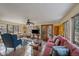 Bright living room featuring tile floors, a ceiling fan, a comfortable pink sofa and views of the outdoors at 3831 S Hillcrest Dr, Denver, CO 80237