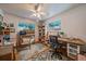 Functional home office provides ample workspace, natural light from two windows, and built-in shelving for storage at 3831 S Hillcrest Dr, Denver, CO 80237