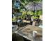 Relaxing patio area furnished with comfortable seating, lush greenery, and a stylish outdoor umbrella at 3831 S Hillcrest Dr, Denver, CO 80237