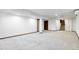 Finished basement with carpeted floor and staircase at 5385 Camargo Rd, Littleton, CO 80123