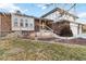 Two-story brick home with yellow front door and landscaping at 5385 Camargo Rd, Littleton, CO 80123