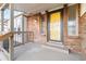 Front entry with yellow door and covered porch at 5385 Camargo Rd, Littleton, CO 80123