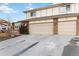 Two-car attached garage with tan doors and brick exterior at 5385 Camargo Rd, Littleton, CO 80123