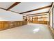 Gathering room with brick fireplace, built-in shelving, and view to kitchen at 5385 Camargo Rd, Littleton, CO 80123