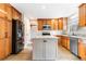 Updated kitchen featuring wood cabinets and a large island at 5385 Camargo Rd, Littleton, CO 80123