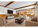 Living room with a high ceiling, wood beams, and comfy furniture at 5385 Camargo Rd, Littleton, CO 80123