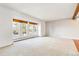 Spacious living room featuring large windows and carpeted floors at 5385 Camargo Rd, Littleton, CO 80123