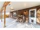 Covered brick patio with concrete flooring and wood storage at 5385 Camargo Rd, Littleton, CO 80123