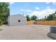 Expansive backyard featuring a detached garage, gravel, mature trees, and perimeter fencing at 742 Hanover St, Aurora, CO 80010
