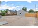 Large backyard area with a detached garage, gravel ground, and partial fencing at 742 Hanover St, Aurora, CO 80010