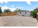 View of backyard area with gravel, some stone accents, fencing, and access to the house at 742 Hanover St, Aurora, CO 80010