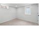 Bright basement area with neutral carpet and natural light from two windows at 742 Hanover St, Aurora, CO 80010