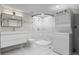 Modern bathroom featuring marble tile, updated fixtures, and a convenient washer/dryer combo at 742 Hanover St, Aurora, CO 80010