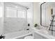 Modern bathroom with marble-style tiles, updated fixtures, and a soaking tub at 742 Hanover St, Aurora, CO 80010