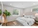 Bright bedroom with a neutral color palette, large window, and stylish furniture at 742 Hanover St, Aurora, CO 80010
