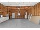 Open garage interior with exposed wood frame, workbench, and ample storage space at 742 Hanover St, Aurora, CO 80010