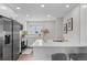 Bright kitchen with quartz countertops, stainless steel appliances, breakfast bar, and stylish finishes at 742 Hanover St, Aurora, CO 80010