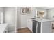 Updated kitchen features stainless appliances, white cabinets, and an island for dining at 742 Hanover St, Aurora, CO 80010