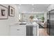 Bright, remodeled kitchen with stainless steel appliances, white cabinets, and an island at 742 Hanover St, Aurora, CO 80010