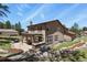 Large backyard with covered patio, built-in grill, and landscaped yard at 7947 Monarch Rd, Larkspur, CO 80118