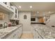 Basement bar area with sink, granite countertops, and cabinet space at 7947 Monarch Rd, Larkspur, CO 80118