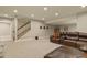 Spacious basement living area featuring plush carpeting, recessed lighting and walk-up stairs at 7947 Monarch Rd, Larkspur, CO 80118