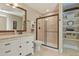Bright bathroom showcases stylish vanity with framed mirror and walk-in shower at 7947 Monarch Rd, Larkspur, CO 80118