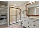 Renovated bathroom boasts stylish vanity with framed mirror and walk-in shower at 7947 Monarch Rd, Larkspur, CO 80118