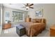 Charming bedroom features a ceiling fan, large window and decorative furniture at 7947 Monarch Rd, Larkspur, CO 80118