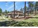 Beautiful home exterior with private back yard in a wooded setting at 7947 Monarch Rd, Larkspur, CO 80118