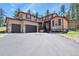 Charming two-story home with a three-car garage, stone accents, and red shutters on a spacious lot at 7947 Monarch Rd, Larkspur, CO 80118