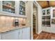 Kitchen with stone countertops, stainless steel appliances, and custom cabinets for ample storage at 7947 Monarch Rd, Larkspur, CO 80118