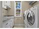 Functional laundry room with a new washer and dryer, granite countertops, and storage at 7947 Monarch Rd, Larkspur, CO 80118