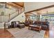 Open-concept living room with hardwood floors, comfortable seating, and a view of the kitchen at 7947 Monarch Rd, Larkspur, CO 80118