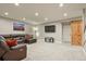 Spacious living room features plush seating, recessed lighting, and a stylish sliding barn door at 7947 Monarch Rd, Larkspur, CO 80118