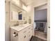 A bright bathroom featuring marble countertops, dual sinks, and neutral-toned walls creating a clean and modern aesthetic at 17404 E Prentice Cir, Centennial, CO 80015